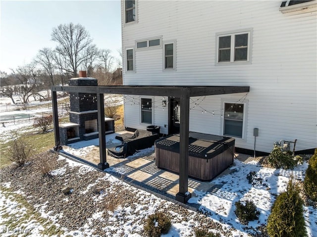 exterior space with fence and a hot tub