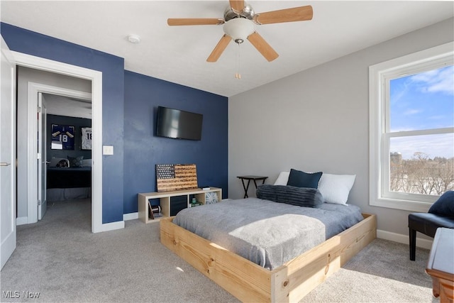 carpeted bedroom featuring ceiling fan and baseboards