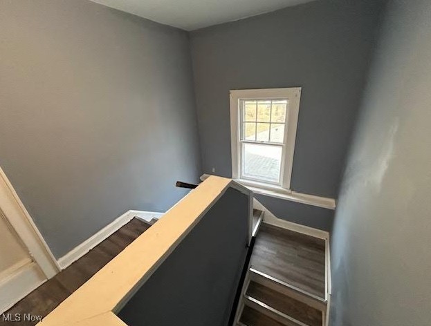 stairs with baseboards and wood finished floors