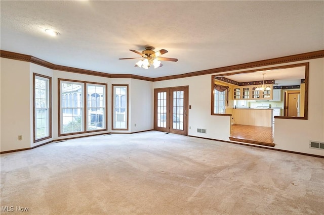 unfurnished living room featuring ornamental molding, carpet, and baseboards