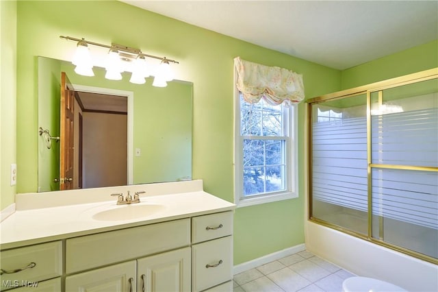 bathroom featuring baseboards, vanity, bath / shower combo with glass door, and tile patterned floors