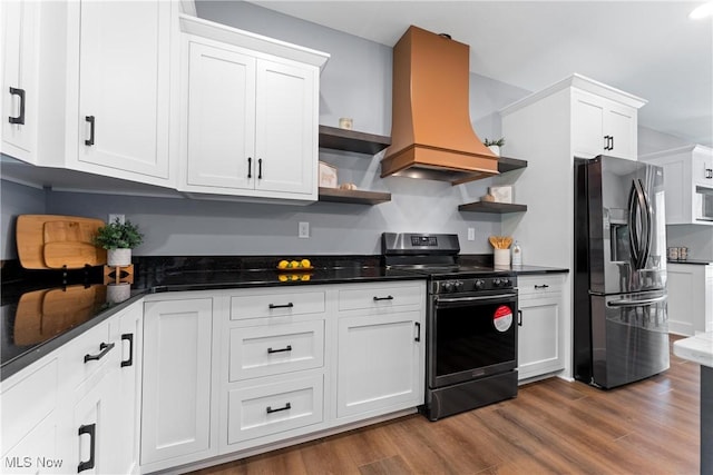 kitchen featuring open shelves, stainless steel appliances, white cabinets, wood finished floors, and premium range hood