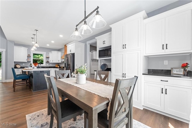 dining space featuring dark wood-style flooring and recessed lighting