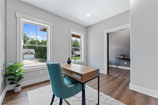 office featuring visible vents, baseboards, wood finished floors, and recessed lighting