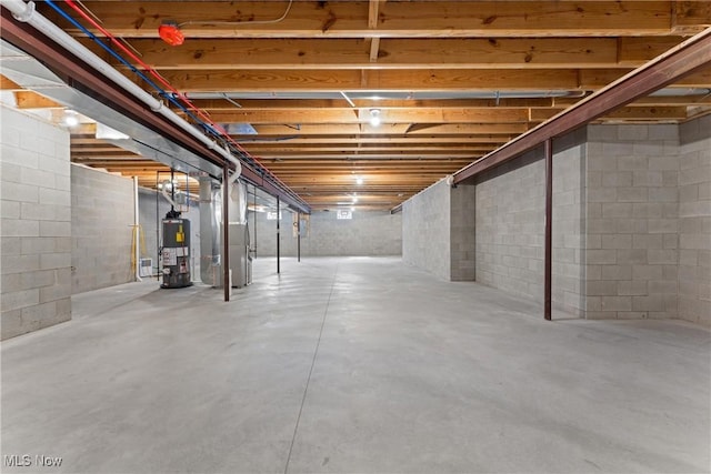 unfinished basement featuring heating unit and water heater