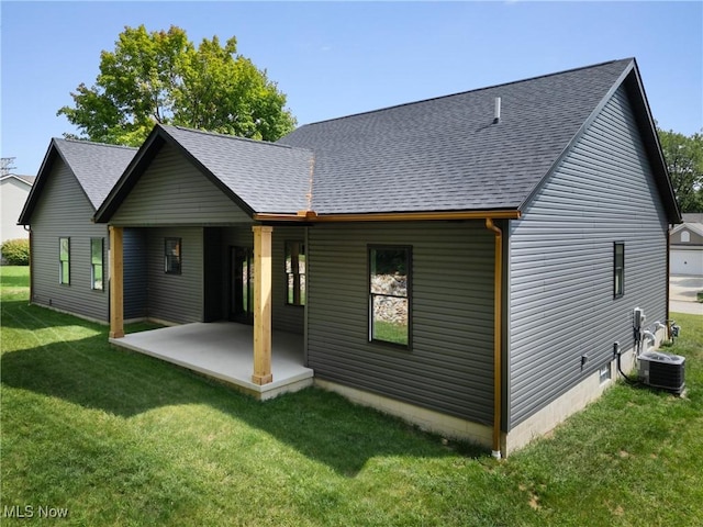 back of house with a patio, central AC, crawl space, roof with shingles, and a lawn