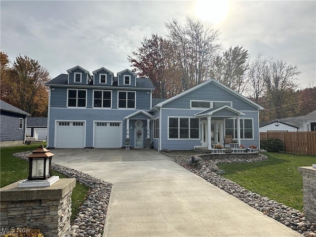 view of front of house featuring a front yard, fence, and driveway