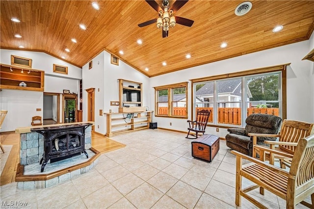 living area featuring wooden ceiling, visible vents, baseboards, ornamental molding, and a wood stove