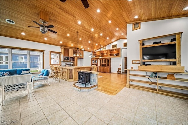 living area with wooden ceiling, ceiling fan, visible vents, and light tile patterned flooring