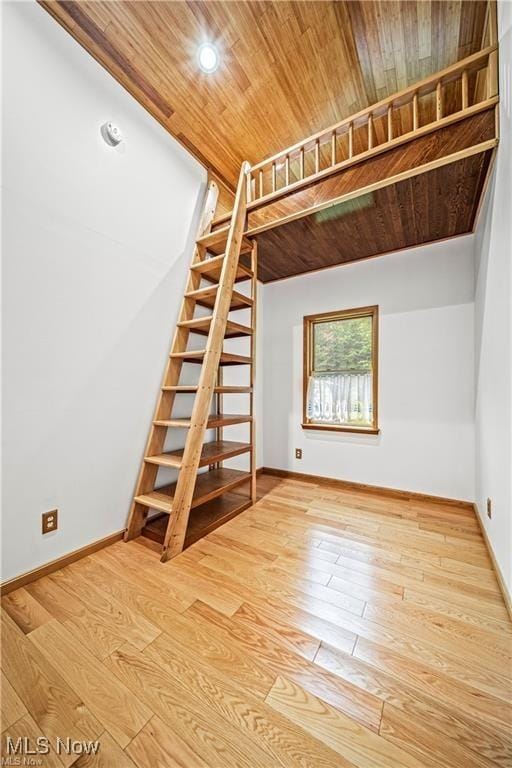 interior space featuring wood ceiling, stairs, baseboards, and wood-type flooring