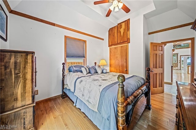 bedroom with lofted ceiling, baseboards, and light wood-style floors