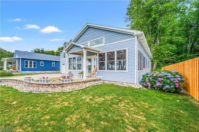 back of house with a patio area, fence, and a yard