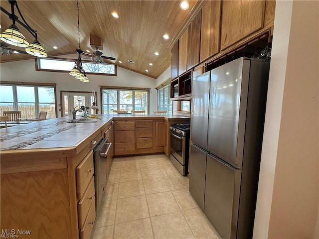 kitchen featuring stainless steel appliances, brown cabinetry, wooden ceiling, and a wealth of natural light