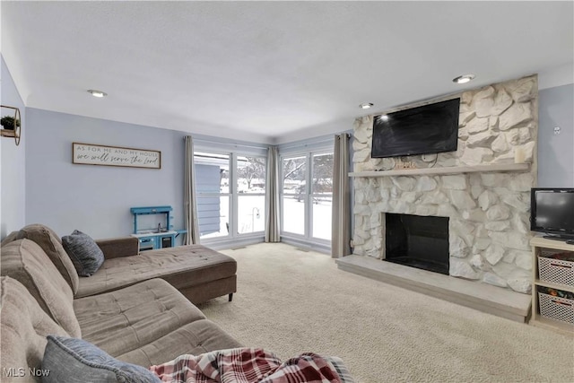 carpeted living room with a fireplace