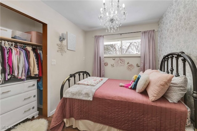 bedroom with a closet and an inviting chandelier