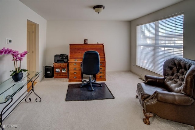 carpeted office featuring baseboards