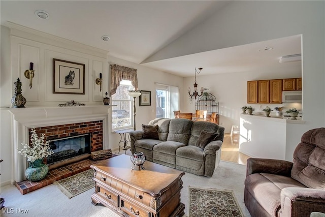 living area featuring carpet floors, a fireplace, and vaulted ceiling