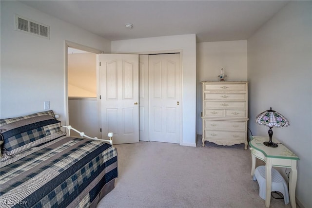 bedroom with light carpet, a closet, and visible vents