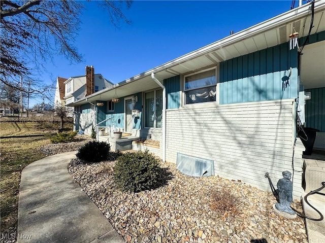 view of property exterior with brick siding