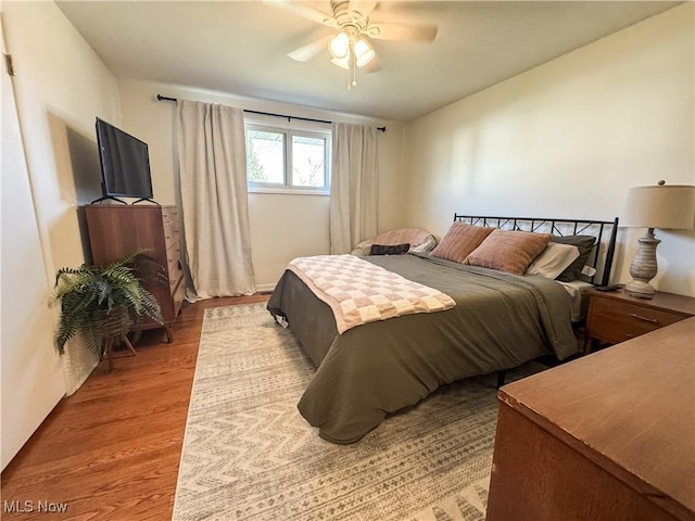 bedroom with light wood-style flooring and ceiling fan