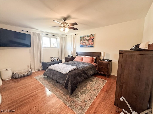 bedroom with ceiling fan and wood finished floors