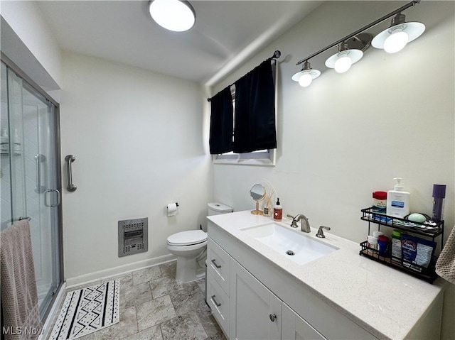 full bathroom with heating unit, toilet, a shower stall, vanity, and baseboards