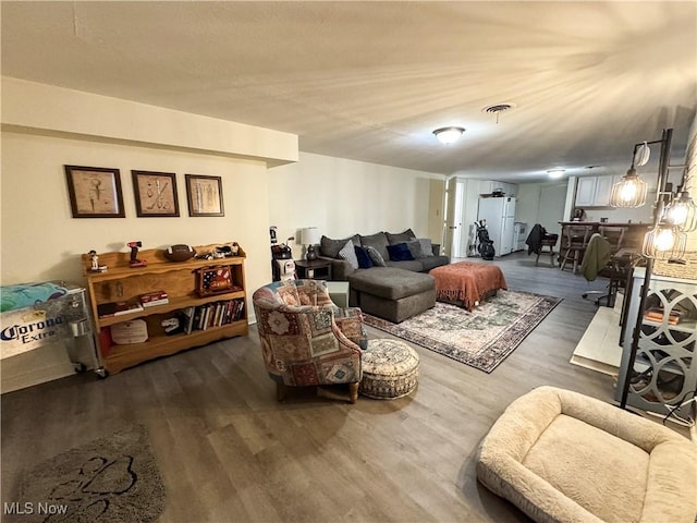 living room with visible vents and wood finished floors