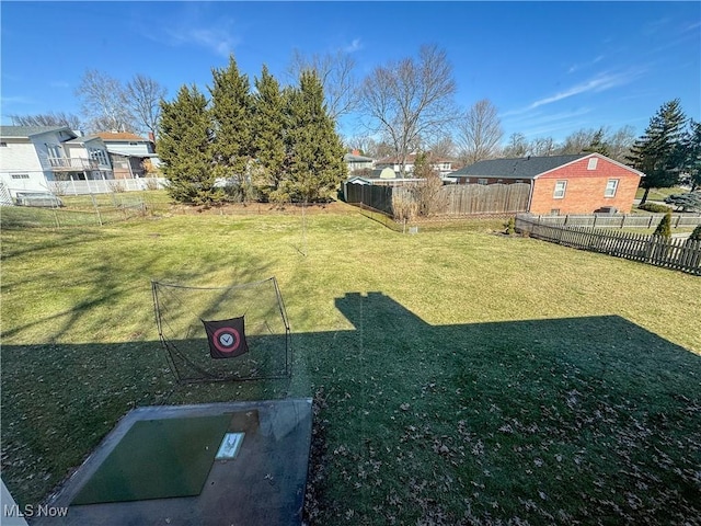 view of yard with a residential view and fence