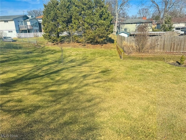 view of yard with fence and a residential view