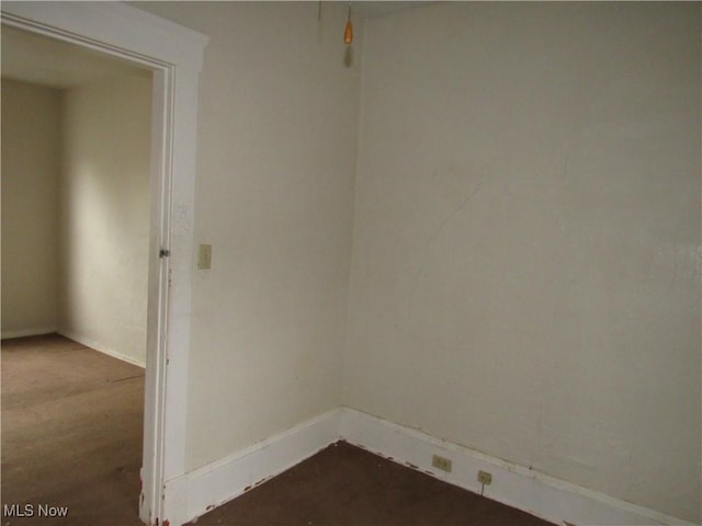 spare room with baseboards