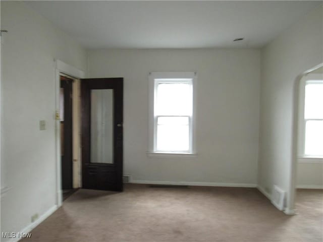 carpeted empty room with baseboards