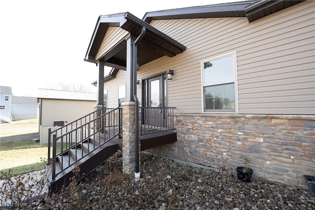 property entrance featuring stone siding