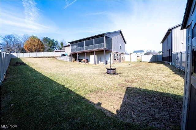 view of yard featuring a sunroom and a fenced backyard