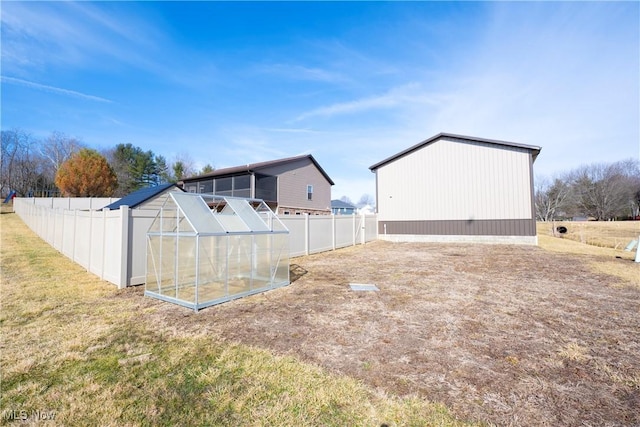 view of yard with an exterior structure, an outdoor structure, and fence