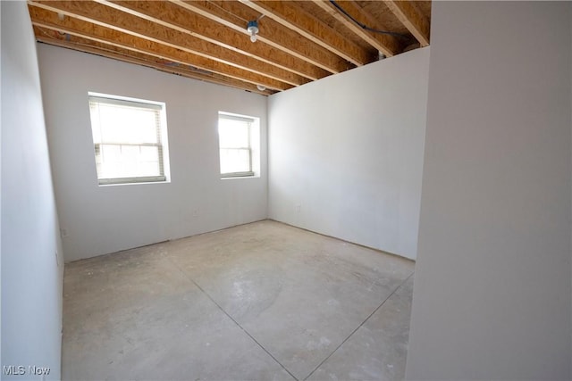 unfurnished room with concrete flooring