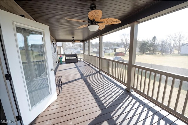 wooden deck featuring a ceiling fan