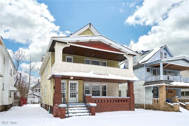 1292 E 137th St, East Cleveland, OH 44112 - view of front of home with brick siding, a porch, and a balcony