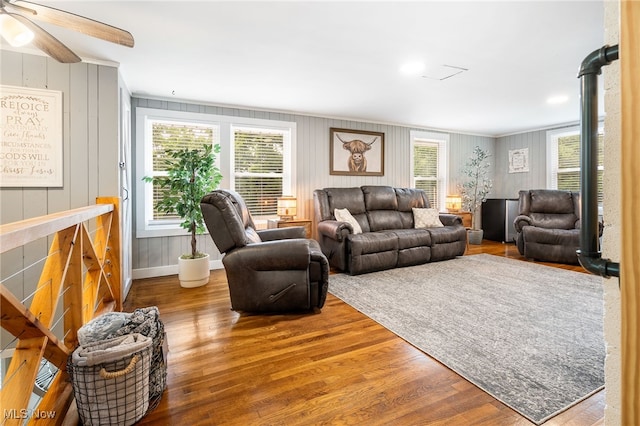 8950 County Road 292, Millersburg, OH 44654 - living area featuring plenty of natural light, wood finished floors, a ceiling fan, and baseboards