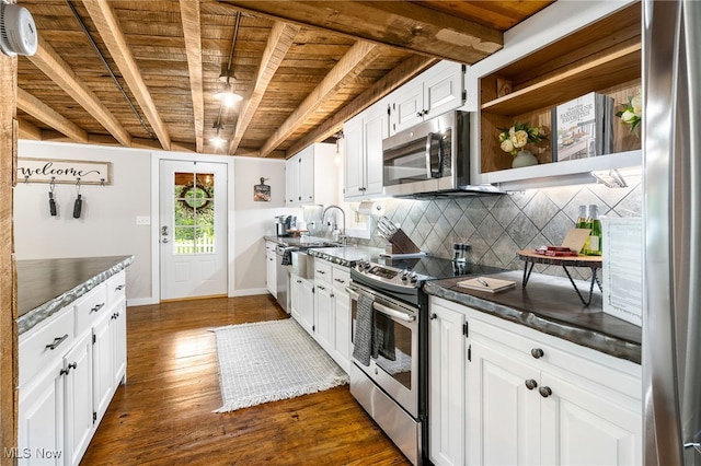 8950 County Road 292, Millersburg, OH 44654 - kitchen with stainless steel appliances, dark countertops, wooden ceiling, and decorative backsplash