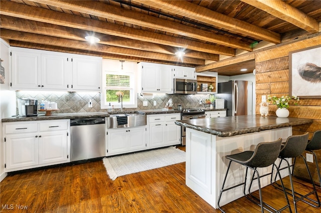 8950 County Road 292, Millersburg, OH 44654 - kitchen with dark wood finished floors, stainless steel appliances, dark countertops, white cabinetry, and a sink