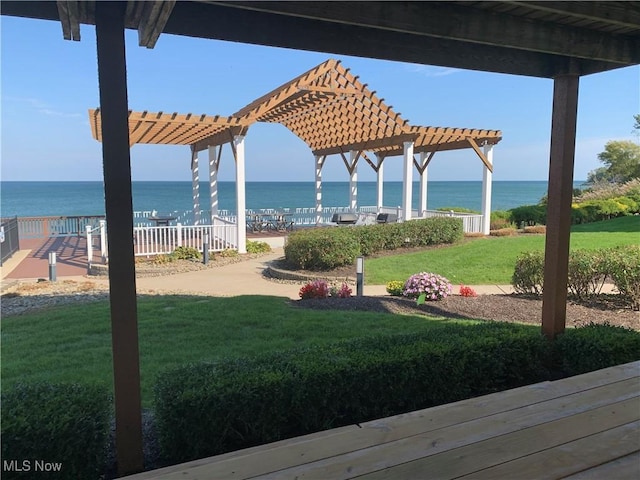 view of yard with a water view and a pergola