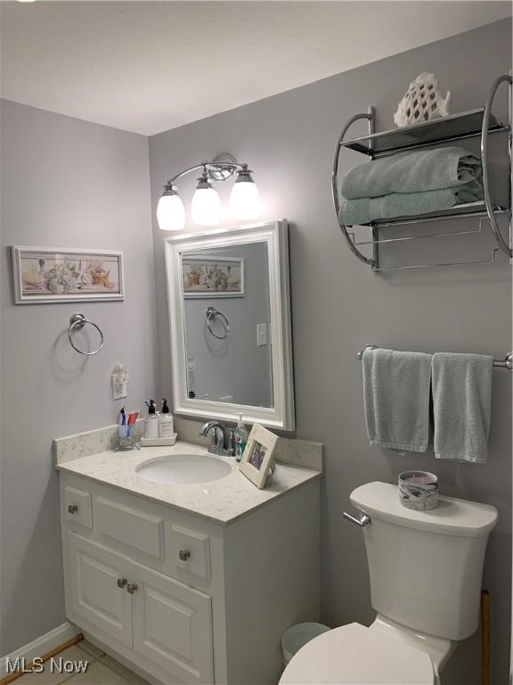 half bath with vanity and toilet