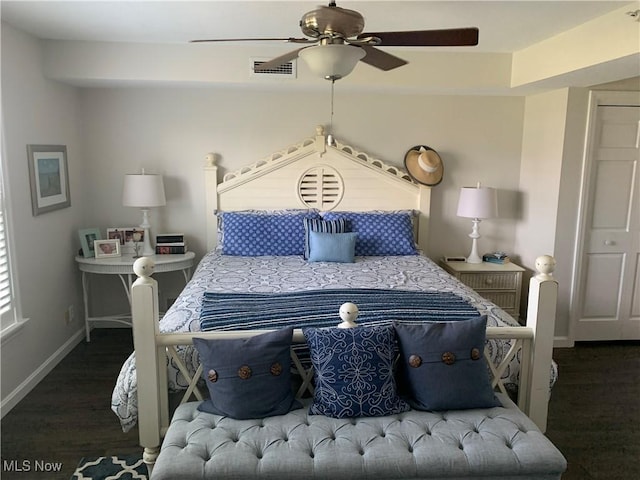 bedroom featuring baseboards, visible vents, ceiling fan, and wood finished floors