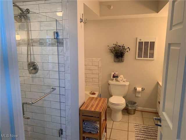 bathroom with tile patterned flooring, a shower stall, and toilet