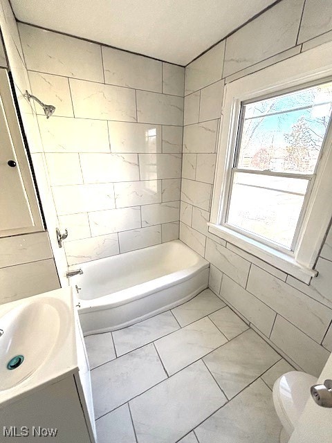 full bath with toilet, vanity, and shower / tub combination