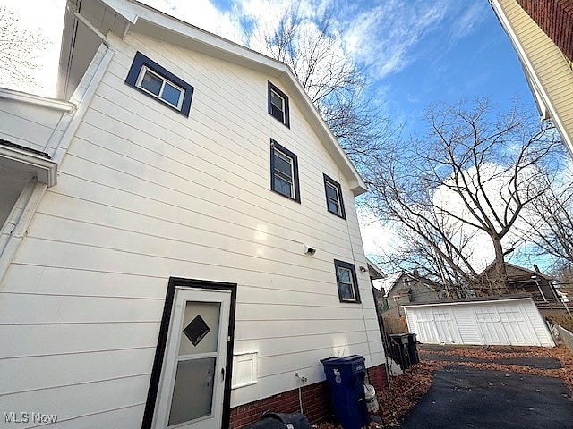 back of house with an outbuilding