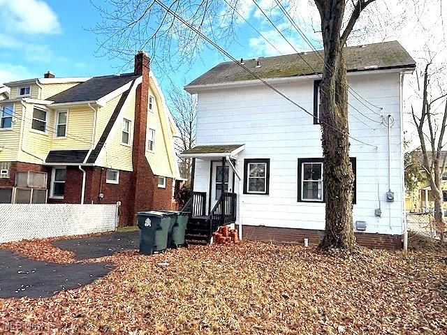 back of house featuring fence