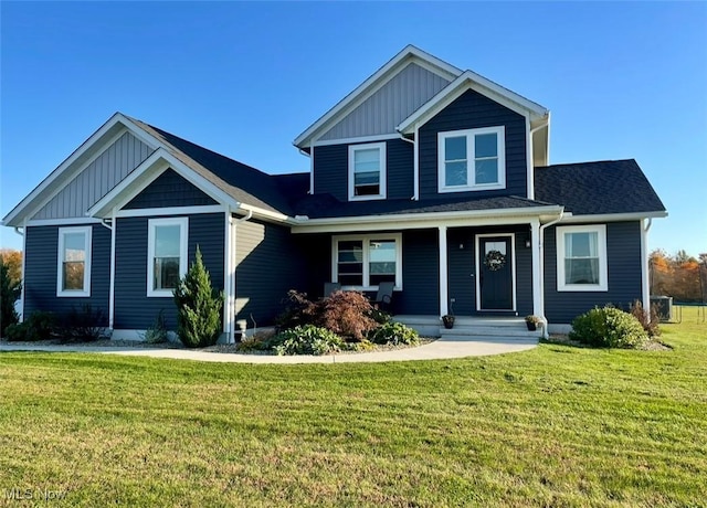 view of front of home featuring covered porch, a front lawn, and board and batten siding