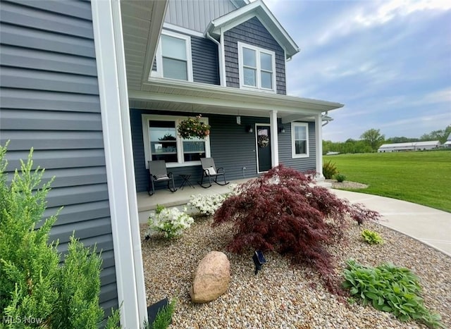 view of front of home with a front yard and covered porch