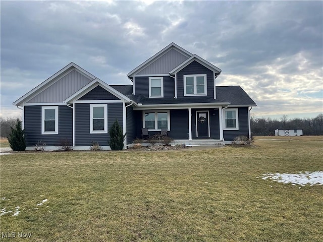 view of front of house featuring board and batten siding and a front lawn